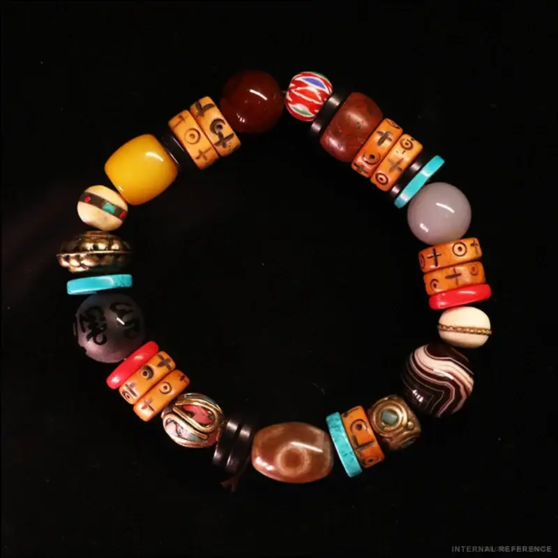 Turquoise, Agate & Dzi-Style Bead Bracelet on a neutral background